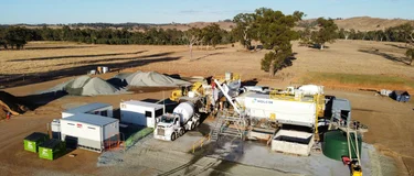 Aerial view of a Holcim mobile concrete batching plant on a cleared rural site.
