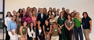 SHE Leads participants from Holcim businesses around the world pose for a group photo during their immersion week in Zug, Switzerland, with a senior leader in a dark suit standing at the centre.