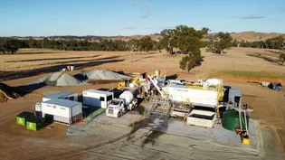 Aerial view of a Holcim mobile concrete batching plant on a cleared rural site.