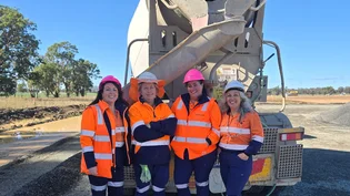 Four women in hi-vis workwear stand in front of a concrete agitator truck in Central West NSW.