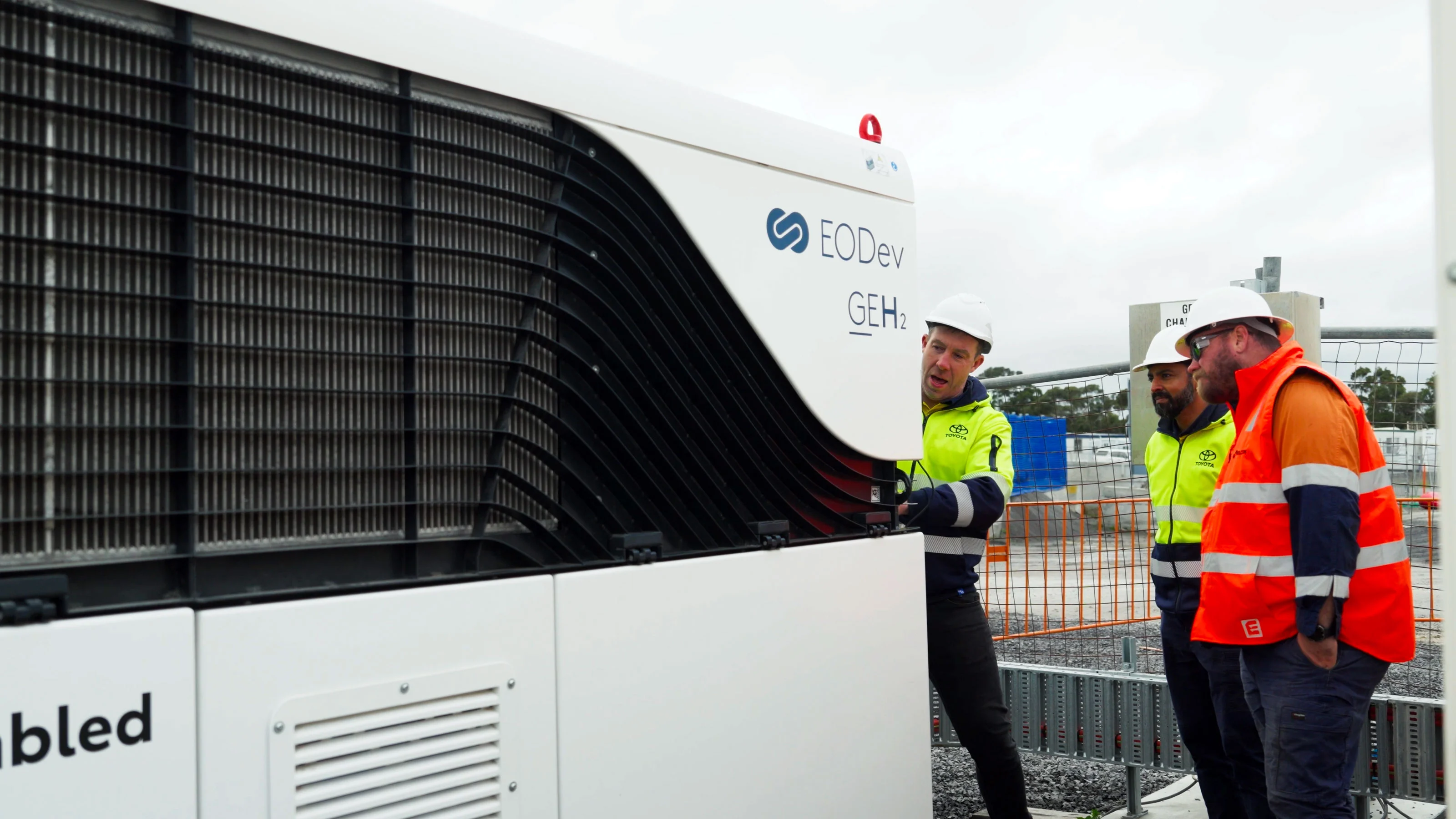 Toyota and site team members inspecting the EODev GEH2 hydrogen fuel cell generator on site at Melbourne Airport.
