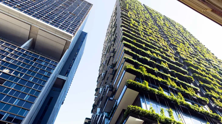 Low angle view of apartment building with vertical garden, sky background with copy space, Green wall-BioWall or living wall is a wall covered with living plants on residential tower in sunny day, Sydney Australia.